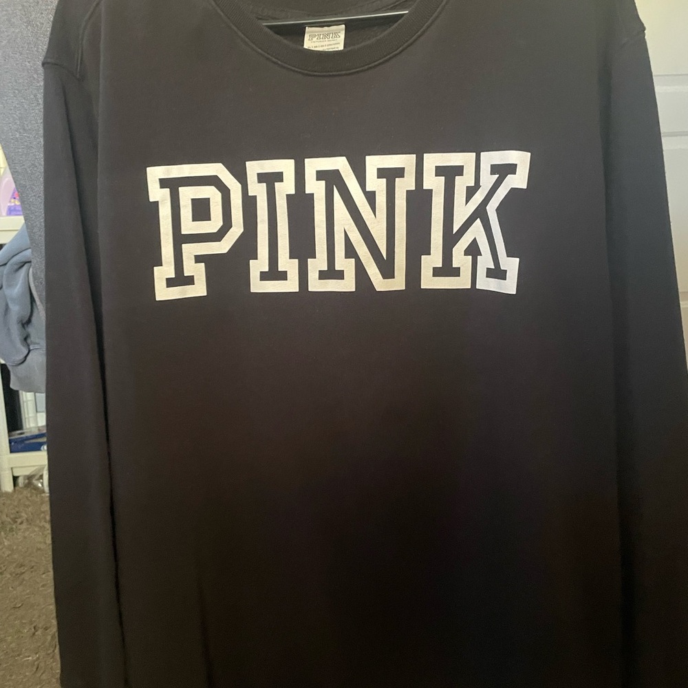 Black Victoria’s Secret crew neck sweatshirt.